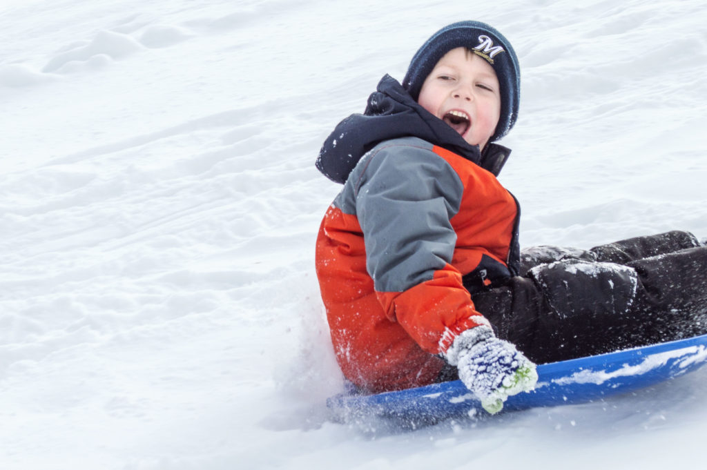 Young Boy Sledding.