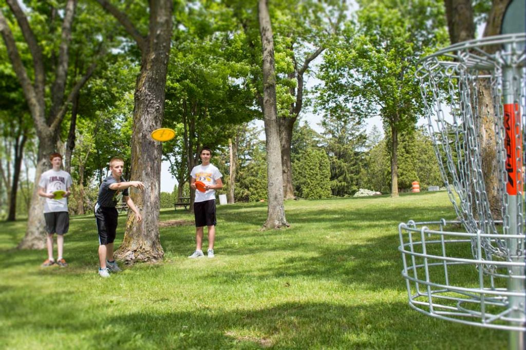 Kids playing frisbee golf.